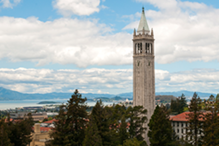 UC Berkeley's campanile against a blue sky with white clouds