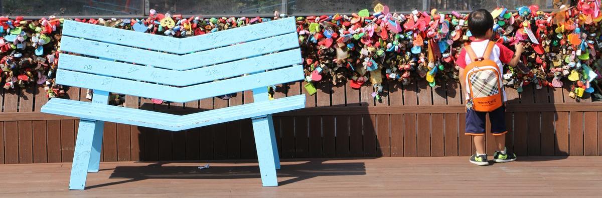 Little boy next to blue bench at N Seoul Tower