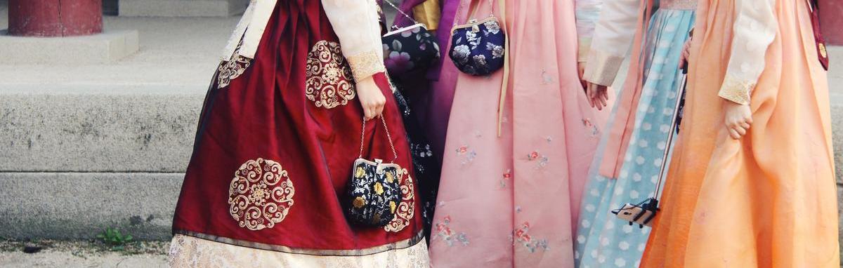 Women wearing hanbok while chatting at a temple